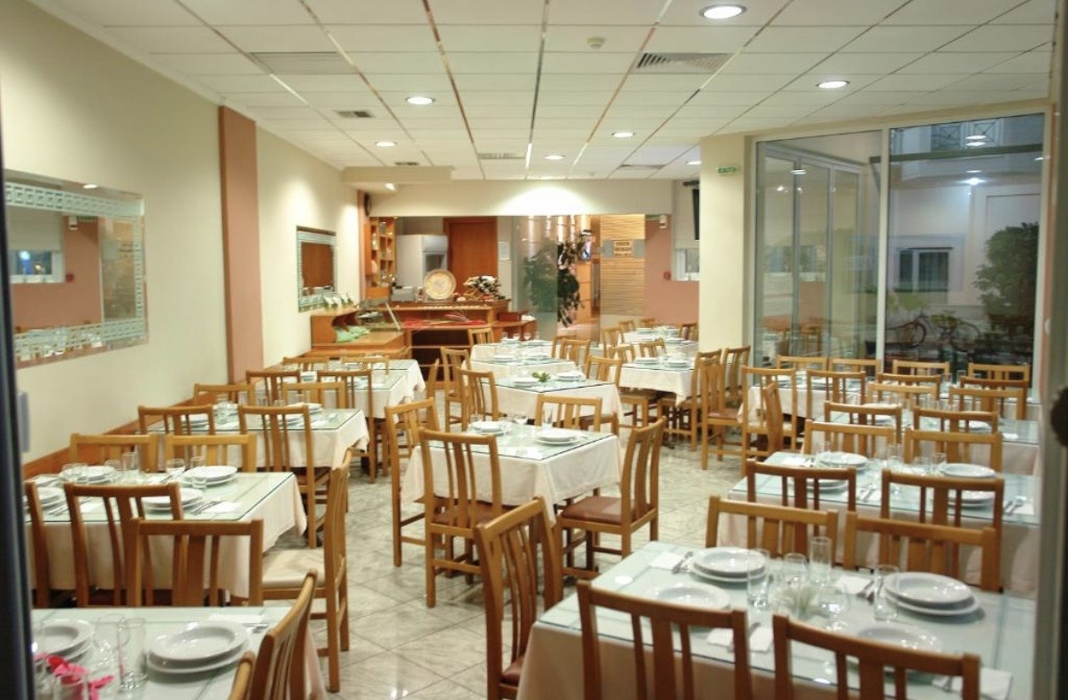 Bright dining room with set tables at Hotel Filoxenia Beach restaurant